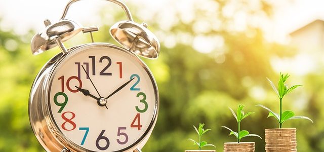Making Some Extra Money Online An old school clock with gold coins on the side from whom grow plants from them.